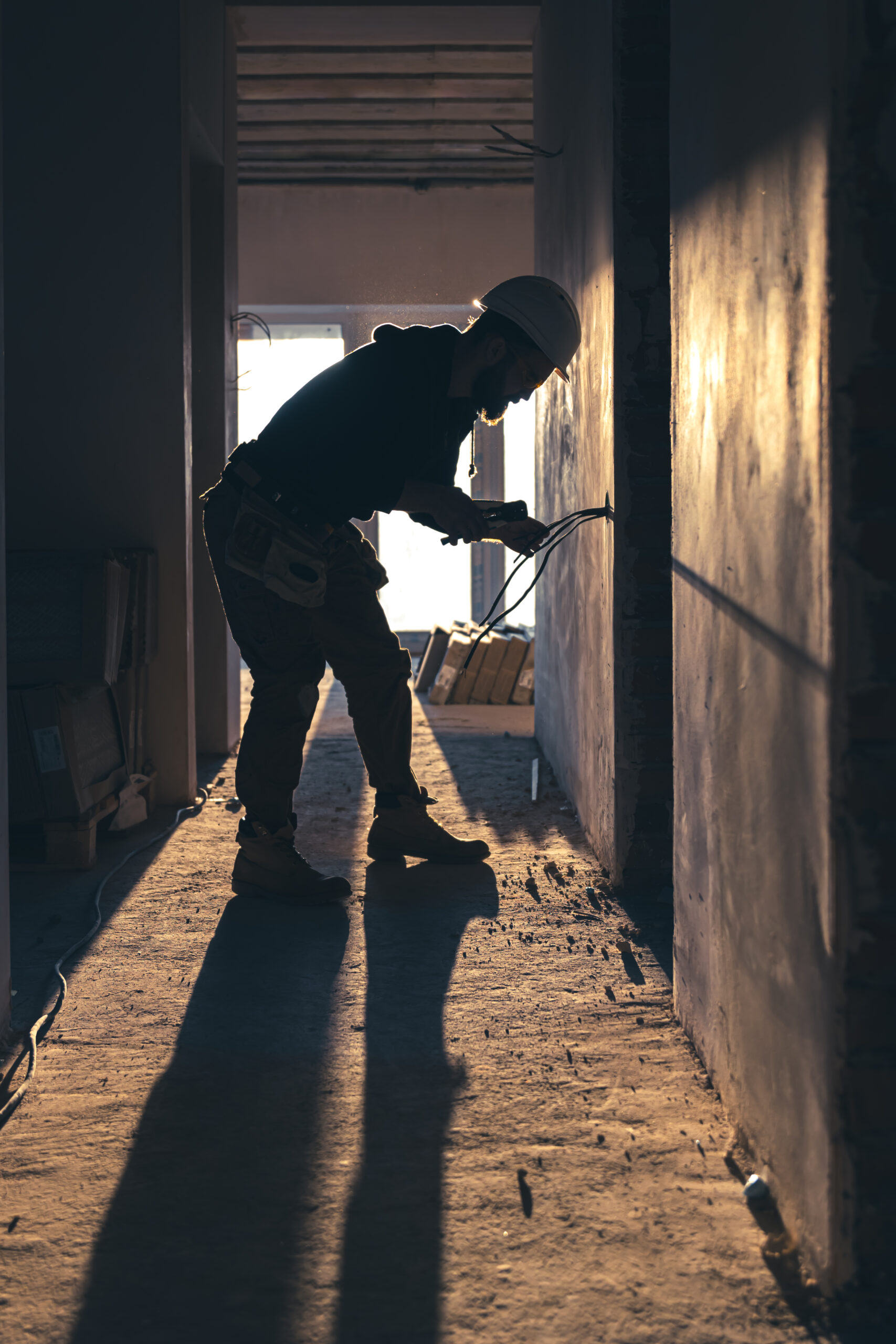 worker is cutting wires with lineman